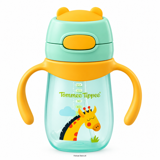 A toddler sippy cup with two handles, featuring a mint green and yellow lid, a clear body, and a cartoon giraffe printed on the front. The brand name 'Tommee Tippee' is visible on the cup.